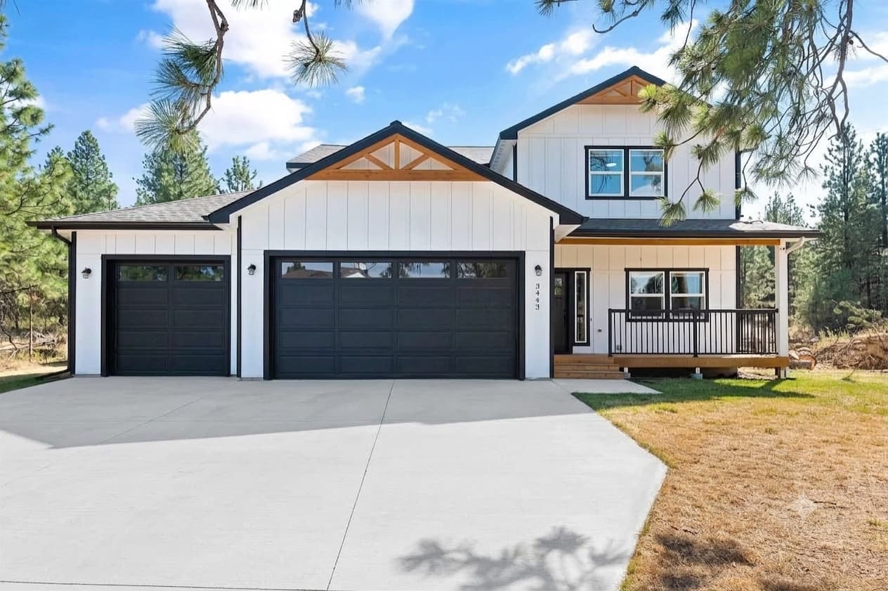 Custom home in the Spokane region with white board-and-batten siding and black trim